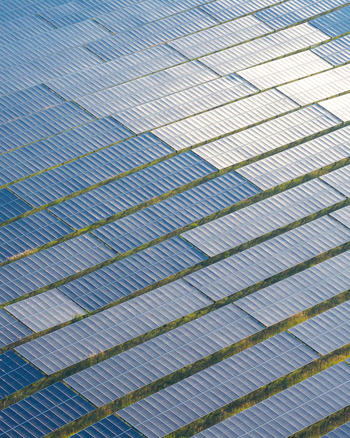 Aerial view of a large solar farm with rows of photovoltaic panels reflecting sunlight in Konin Greater Poland Voivod Poland. Aerial view of a large solar farm with rows of photovoltaic panels reflecting sunlight in Konin Greater Poland Voivod Poland.