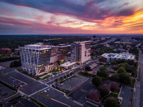 Reston Virginia United States 27 May 2020 Aerial view of the modern office buildings and urban development in Reston Town Center during a vibrant sunset. Reston Virginia United States 27 May 2020 Aerial view of the modern office buildings and urban development in Reston Town Center during a vibrant sunset.