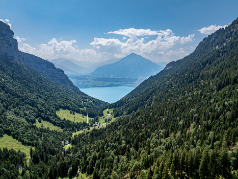 Aerial view of the Justistal valley leading towards Lake Thun framed by the forested slopes of the Niederhorn mountain range in Sigriswil Bern Switzerland. Aerial view of the Justistal valley leading towards Lake Thun framed by the forested slopes of the Niederhorn mountain range in Sigriswil Bern Switzerland.