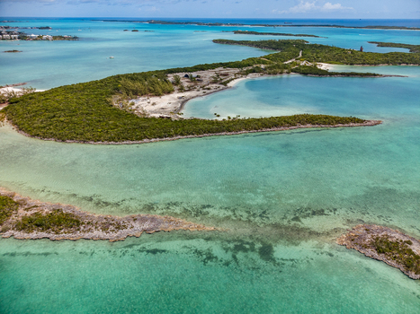 Aerial view of Crab Cay featuring turquoise waters lush green vegetation and sandy beaches in Exuma Exuma The Bahamas. Aerial view of Crab Cay featuring turquoise waters lush green vegetation and sandy beaches in Exuma Exuma The Bahamas.