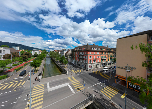 Aerial view of the Schuss canal flowing through the urban landscape with historic buildings and a street intersection under a cloudy sky in Biel Bienne Canton of Bern Switzerland. Aerial view of the Schuss canal flowing through the urban landscape with historic buildings and a street intersection under a cloudy sky in Biel Bienne Canton of Bern Switzerland.