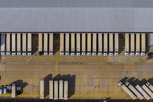 Aerial view of Hemel Hempstead Industrial Estate with rows of semi trailers parked at a large warehouse loading dock in London England United Kingdom. Aerial view of Hemel Hempstead Industrial Estate with rows of semi trailers parked at a large warehouse loading dock in London England United Kingdom.
