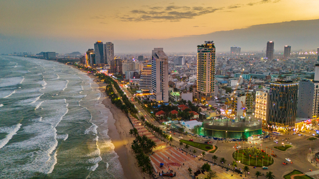 Aerial view of Da Nang coastline featuring modern skyscrapers sandy beach and crashing waves under a warm golden hour sky Da Nang Vietnam. Aerial view of Da Nang coastline featuring modern skyscrapers sandy beach and crashing waves under a warm golden hour sky Da Nang Vietnam.