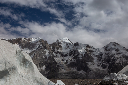 View of the Baltoro Glacier with its massive ice formations and snow capped mountain peaks under a cloudy sky in Baltoro Gilgit Baltistan Pakistan.