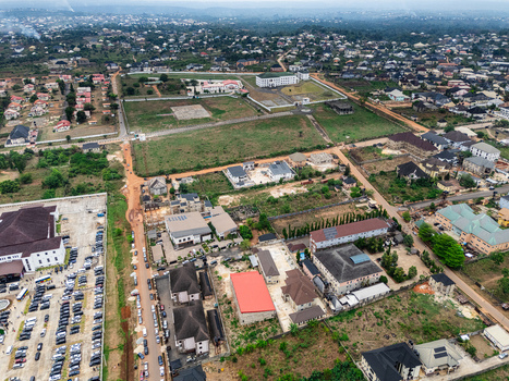 Aerial view of buildings and roads interspersed with lush green spaces under a cloudy sky Ihie Ndume Umuahia Abia Nigeria. Aerial view of buildings and roads interspersed with lush green spaces under a cloudy sky Ihie Ndume Umuahia Abia Nigeria.