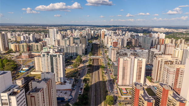Brasilia Brazil 12 September 2026 Aerial view of the modern urban skyline of Brasilia with tall residential buildings a central railway corridor and clear blue sky.