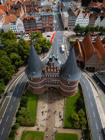 Aerial view of the iconic Holsten Gate standing proudly against the urban tapestry of L&uuml;beck framed by roads and pathways Schleswig Holstein Germany.