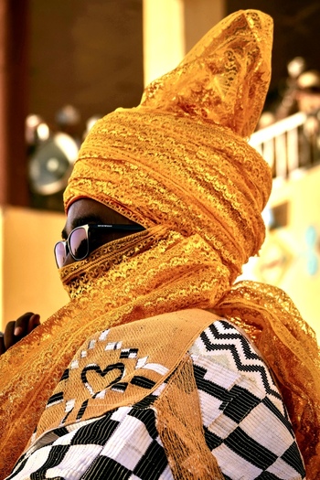 Zaria city Nigerian 21 March 2026 View of a figure in a brilliant golden yellow headwrap and bold black and white patterned tunic showcasing vibrant attire. Zaria city Nigerian 21 March 2026 View of a figure in a brilliant golden yellow headwrap and bold black and white patterned tunic showcasing vibrant attire.