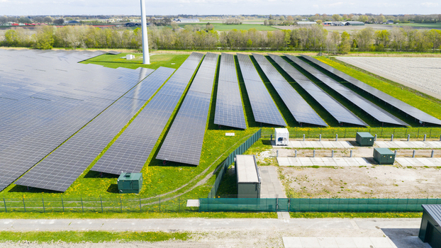 Aerial view of battery storage and mobile container charging at De Dijken Solar Park near Warmenhuizen supporting grid balance renewable energy and flexible power use. Aerial view of battery storage and mobile container charging at De Dijken Solar Park near Warmenhuizen supporting grid balance renewable energy and flexible power use.