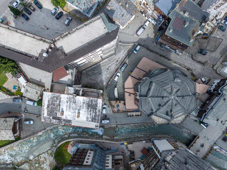 Aerial view of the mountain village of Breuil Cervinia with alpine buildings winding roads and a clear stream flowing through the town center in Breuil Cervinia Aosta Valley Italy. Aerial view of the mountain village of Breuil Cervinia with alpine buildings winding roads and a clear stream flowing through the town center in Breuil Cervinia Aosta Valley Italy.