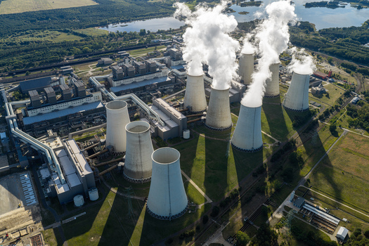 Aerial view of Janschwalde Power Station with its cooling towers emitting steam set within an industrial landscape surrounded by green fields in Peitz Brandenburg Germany. Aerial view of Janschwalde Power Station with its cooling towers emitting steam set within an industrial landscape surrounded by green fields in Peitz Brandenburg Germany.