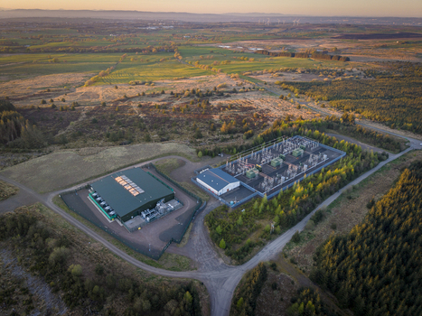 Aerial view of the industrial facility at Eaglesham moor surrounded by rolling hills and moorland during sunset Kilmarnock Scotland United Kingdom.