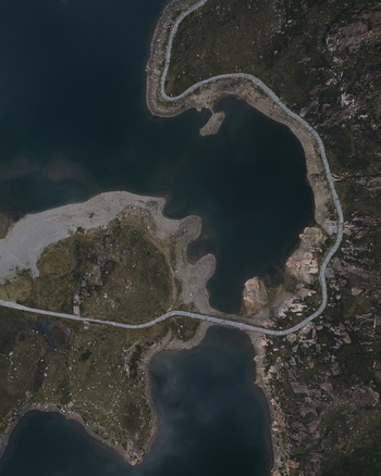 Aerial view of Snowdon mountain lake with winding paths and rugged terrain in Caernarfon Wales United Kingdom.