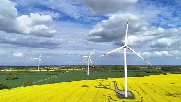 Aerial view of wind turbines in a yellow rapeseed field Germany. Aerial view of wind turbines in a yellow rapeseed field Germany.