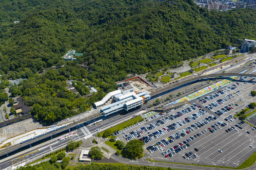Aerial view of Taipei Zoo Station with its modern architecture adjacent large parking lot and surrounding lush green hills in Taipei City Taiwan. Aerial view of Taipei Zoo Station with its modern architecture adjacent large parking lot and surrounding lush green hills in Taipei City Taiwan.