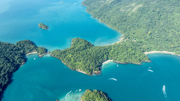 Aerial view of Lagoa Azul with turquoise waters lush green islands and boats in Angra dos Reis Rio de Janeiro Brazil.