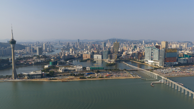 Macao 18 February 2026 Aerial view of Macau Tower and the urban skyline of Macau Island featuring modern skyscrapers the Nam Van Lake and the Sai Van Bridge under a clear sky. Macao 18 February 2026 Aerial view of Macau Tower and the urban skyline of Macau Island featuring modern skyscrapers the Nam Van Lake and the Sai Van Bridge under a clear sky.