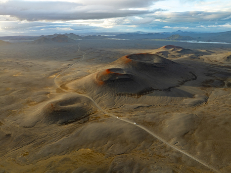 Aerial view of Landmannalaugar volcanic craters and rugged lava fields with a winding dirt road cutting through the dramatic landscape Rangarthing ytra Iceland. Aerial view of Landmannalaugar volcanic craters and rugged lava fields with a winding dirt road cutting through the dramatic landscape Rangarthing ytra Iceland.