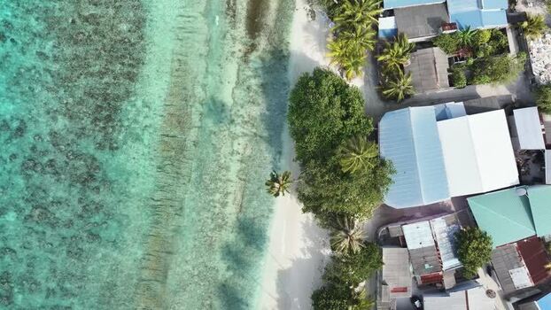 Aerial view of tropical coastline and rooftops in Maalhos Maldives. Aerial view of tropical coastline and rooftops in Maalhos Maldives.