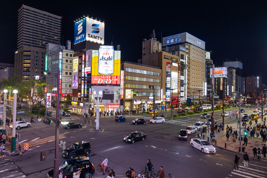 Sapporo Japan 09 May 2026 Aerial view of the busy Susukino intersection at night with illuminated neon signs traffic and pedestrians crossing the street in the city center. Sapporo Japan 09 May 2026 Aerial view of the busy Susukino intersection at night with illuminated neon signs traffic and pedestrians crossing the street in the city center.