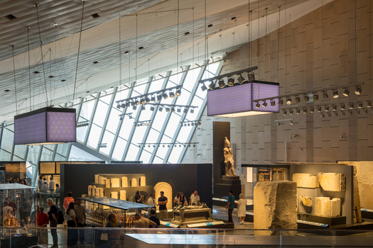 Giza Egypt 16 May 2026 View of the Grand Egyptian Museum interior featuring ancient artifacts statues and visitors under modern lighting and architectural windows.
