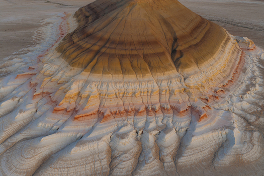 Aerial view of the multi colored layered rock formations and eroded sediment ridges in the desert of Mangystau Region Kazakhstan. Aerial view of the multi colored layered rock formations and eroded sediment ridges in the desert of Mangystau Region Kazakhstan.