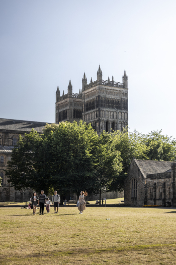Durham United Kingdom 13 July 2026 View of Durham Cathedral rising above a lush green tree in the courtyard with people walking on the grass under a clear blue sky. Durham United Kingdom 13 July 2026 View of Durham Cathedral rising above a lush green tree in the courtyard with people walking on the grass under a clear blue sky.