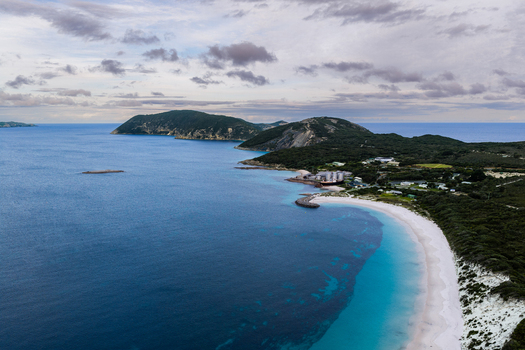 Aerial view of Frenchman Bay with its turquoise waters white sandy beach and surrounding coastal hills in Albany Western Australia Australia. Aerial view of Frenchman Bay with its turquoise waters white sandy beach and surrounding coastal hills in Albany Western Australia Australia.
