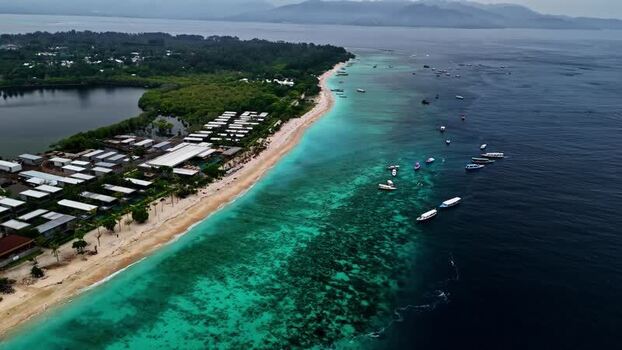 Aerial view of turquoise waters and boats in Bali Indonesia.