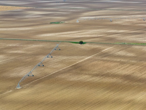 Aerial view of agricultural fields with a central pivot irrigation system stretching across the dry land Neuf Brisach Grand Est France.