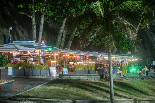 Rio de Janeiro Brazil 08 June 2026 View of a beach kiosk at night with people relaxing under palm trees and lush vegetation in Copacabana.