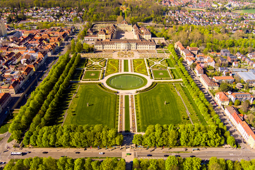 Aerial view of the baroque Ludwigsburg Palace surrounded by manicured gardens lush green lawns and tree lined pathways in Ludwigsburg Baden Wurttemberg Germany.