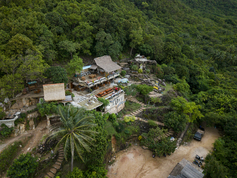 Aerial view of a rustic multi tiered structure nestled amongst verdant trees and foliage Bukit Love Karimunjawa Jawa Tengah Indonesia. Aerial view of a rustic multi tiered structure nestled amongst verdant trees and foliage Bukit Love Karimunjawa Jawa Tengah Indonesia.