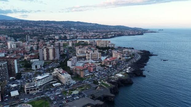 Aerial view of rocky coastline and urban skyline in Catania Italy. Aerial view of rocky coastline and urban skyline in Catania Italy.