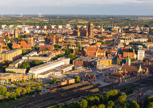 Aerial view of the historic city of Gdansk featuring St. Marys Church red tiled rooftops and the railway station area in Gdansk Pomeranian Voivodeship Poland. Aerial view of the historic city of Gdansk featuring St. Marys Church red tiled rooftops and the railway station area in Gdansk Pomeranian Voivodeship Poland.
