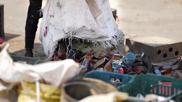 View of a worker collecting plastic bottles in Bogura Bangladesh. View of a worker collecting plastic bottles in Bogura Bangladesh.