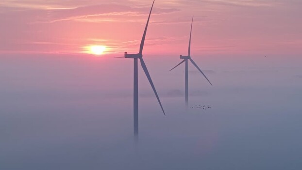 Aerial view of wind turbines above thick fog at sunrise Netherlands. Aerial view of wind turbines above thick fog at sunrise Netherlands.