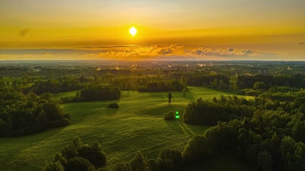 Aerial view of sunset over green fields in Latvia. Aerial view of sunset over green fields in Latvia.