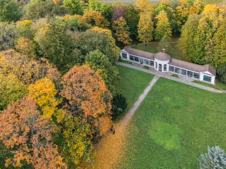 Aerial view of a stately white architectural gem nestled amidst a symphony of vibrant autumn foliage and emerald green lawns Mosovce Zilina Region Slovakia. Aerial view of a stately white architectural gem nestled amidst a symphony of vibrant autumn foliage and emerald green lawns Mosovce Zilina Region Slovakia.