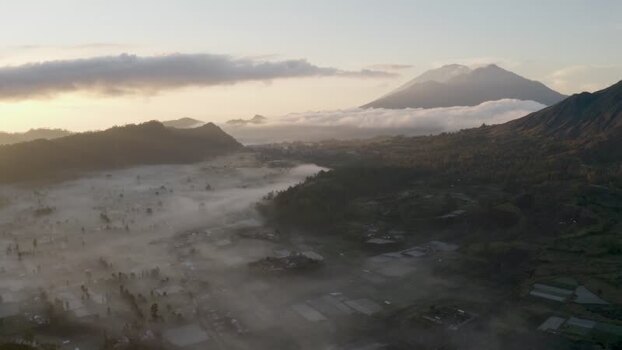 Aerial view of the misty Batur valley and volcanic peaks Indonesia. Aerial view of the misty Batur valley and volcanic peaks Indonesia.