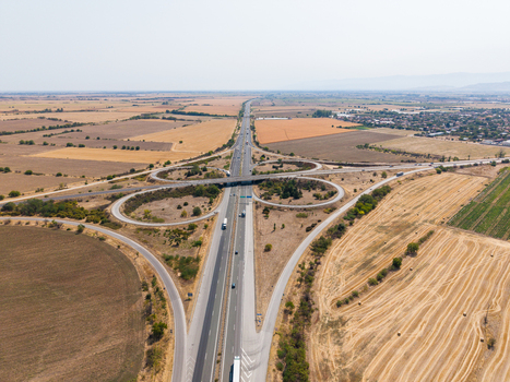 Aerial view of Highway Trakiya interchange with surrounding agricultural fields and rural landscape in Bulgaria. Aerial view of Highway Trakiya interchange with surrounding agricultural fields and rural landscape in Bulgaria.