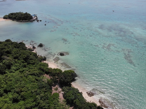 Aerial view of the coastline in the Hyakume area featuring emerald green sea white sandy beach and lush greenery in Nanjo Okinawa Japan. Aerial view of the coastline in the Hyakume area featuring emerald green sea white sandy beach and lush greenery in Nanjo Okinawa Japan.