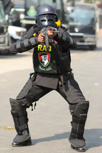 Dhaka Bangladesh 08 January 2017 View of a member of the Rapid Action Battalion RAB in full tactical gear aiming an assault rifle at the RAB Headquarters. Dhaka Bangladesh 08 January 2017 View of a member of the Rapid Action Battalion RAB in full tactical gear aiming an assault rifle at the RAB Headquarters.