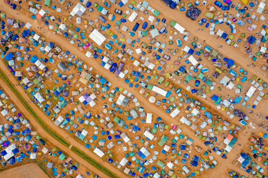 Herzogenaurach Germany 22 July 2022 Aerial view of the Open Beatz Festival campsite with hundreds of colorful tents arranged in rows along dirt paths. Herzogenaurach Germany 22 July 2022 Aerial view of the Open Beatz Festival campsite with hundreds of colorful tents arranged in rows along dirt paths.
