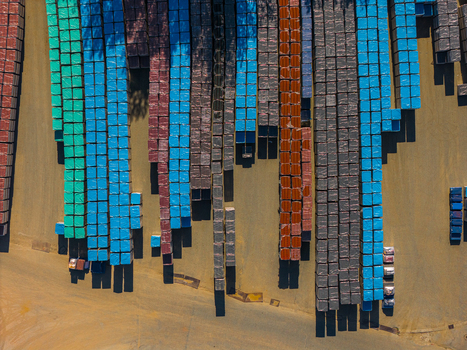 Aerial view of colorful industrial stacks of materials wrapped in plastic in an outdoor storage yard Kyjov South Moravian Region Czechia.