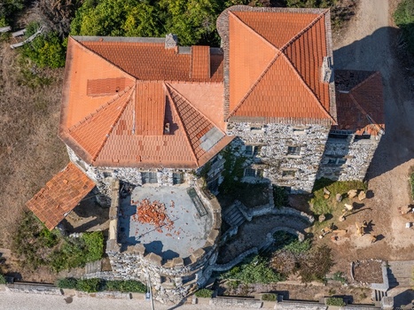 Aerial view of the stone rock house with red tile roofs and a terrace in Cascais Lisboa Portugal.
