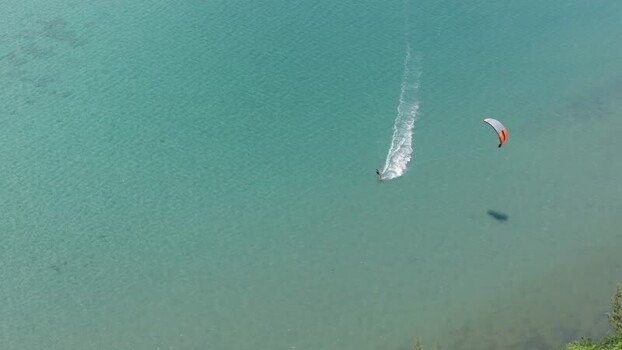 Aerial view of kitesurfer gliding over turquoise water Mauritius.