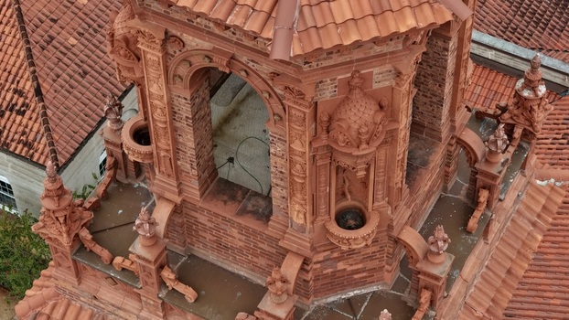 Aerial view of the intricate terracotta architectural details of the Grace United Methodist Church tower featuring ornate carvings and red clay tile roofing in St. Augustine Florida United States. Aerial view of the intricate terracotta architectural details of the Grace United Methodist Church tower featuring ornate carvings and red clay tile roofing in St. Augustine Florida United States.