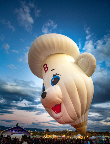 Albuquerque United States 13 October 2017 View of a whimsical hot air balloon shaped like a bear s head rising above a crowd under a vibrant sky. Albuquerque United States 13 October 2017 View of a whimsical hot air balloon shaped like a bear s head rising above a crowd under a vibrant sky.