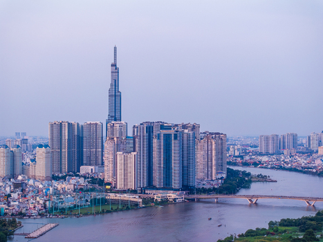 Aerial view of Landmark 81 skyscraper rising above the modern skyline river and bridge in Ho Chi Minh City Vietnam. Aerial view of Landmark 81 skyscraper rising above the modern skyline river and bridge in Ho Chi Minh City Vietnam.